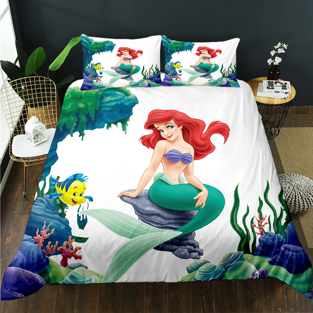 Mermaid-themed bedding set with characters from 'The Little Mermaid' on a bed.