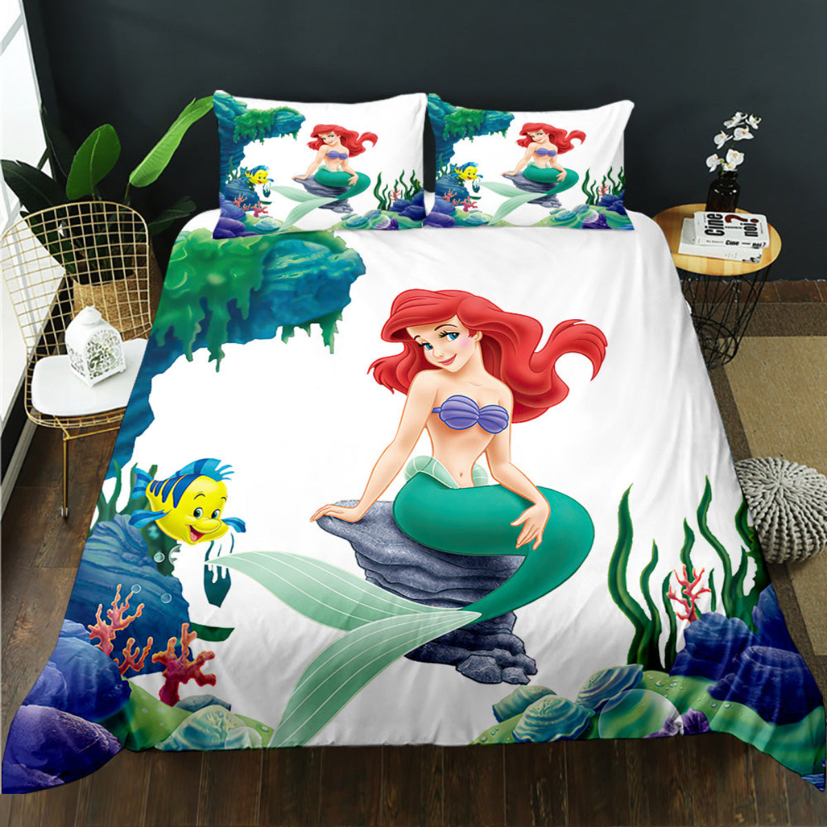 Mermaid-themed bedding set with characters from 'The Little Mermaid' on a bed.