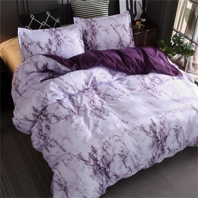 Neatly styled bed with a patterned duvet cover set and matching pillow shams — Anna's Linens