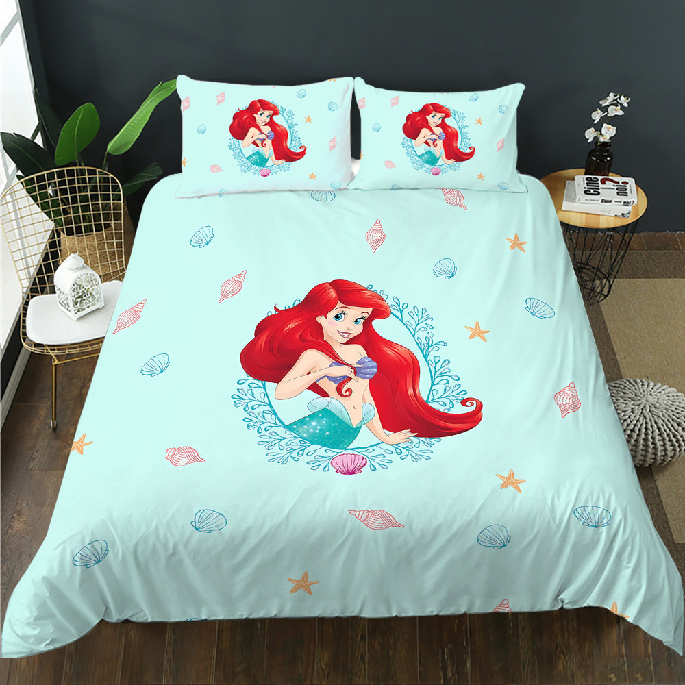 Bedding set with Little Mermaid design on a bed in a room setting.