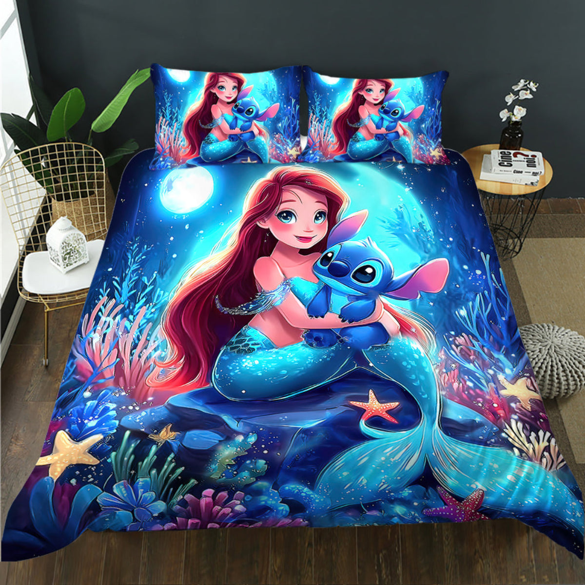 Bedding set with mermaid and blue creature design on a bed in a room.