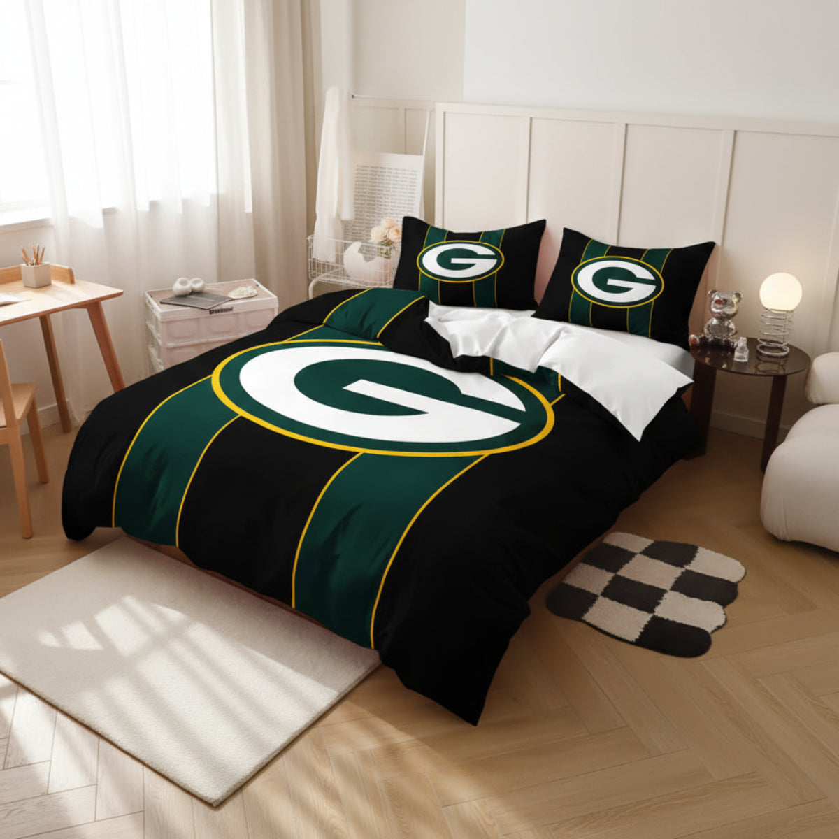A bed dressed in a Green Bay Packers-themed bedding set, featuring a black duvet cover with a large green and white 'G' logo outlined in yellow, matching green and white pillows, and white bedding, shown in a styled bedroom setting.