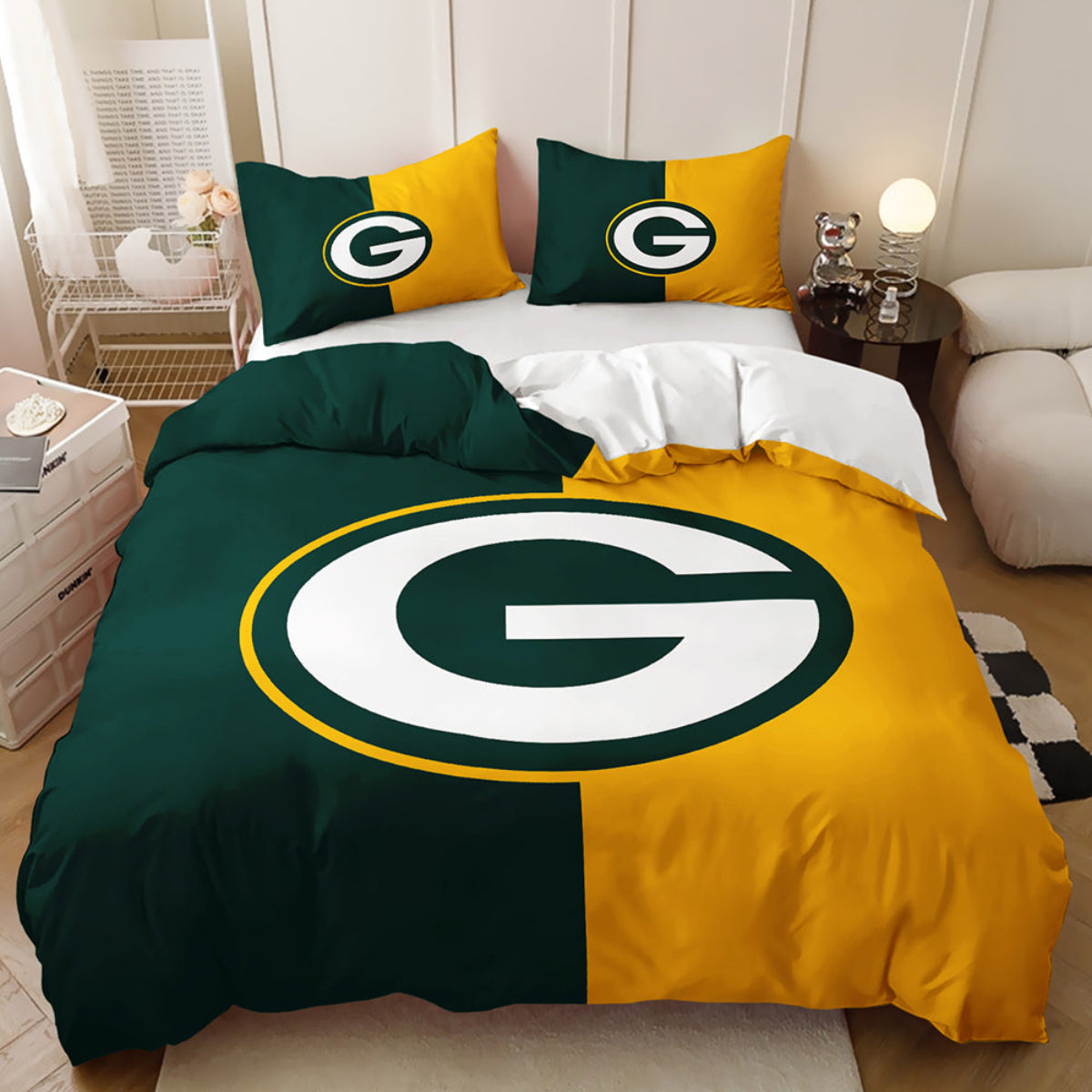 A Green Bay Packers-themed bedding set displayed on a bed in a modern bedroom setting. The set includes a duvet cover and two matching pillowcases featuring the team's green and gold colors with the large 'G' logo.