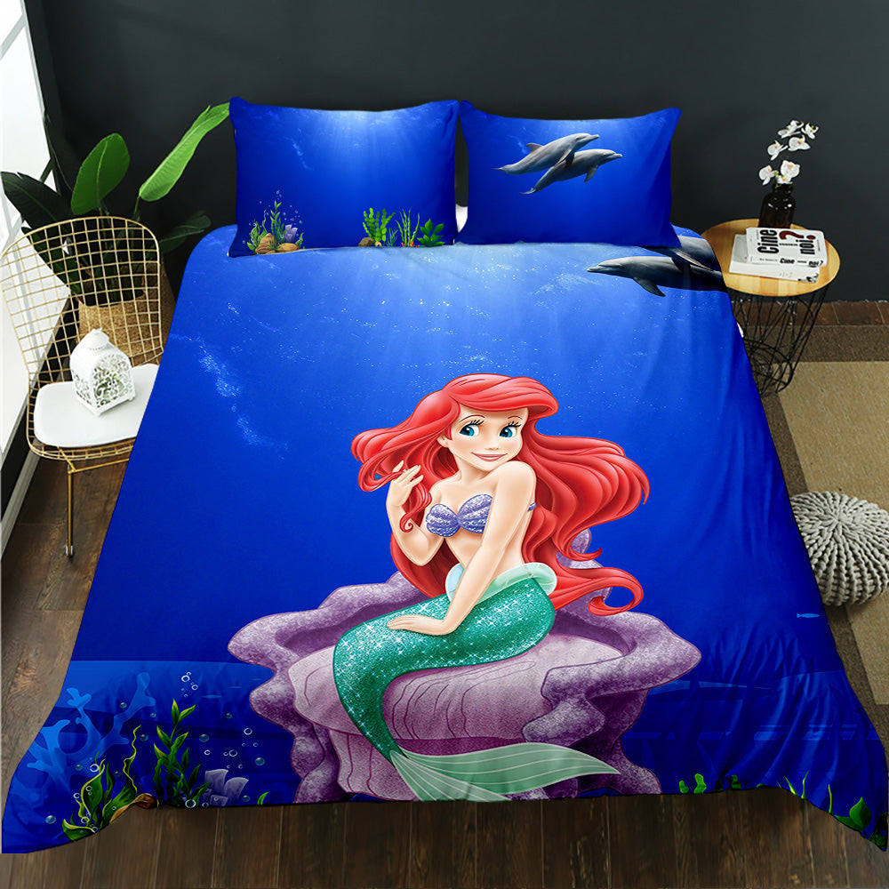 Mermaid-themed bedding set with 'The Little Mermaid' design on a bed in a room.