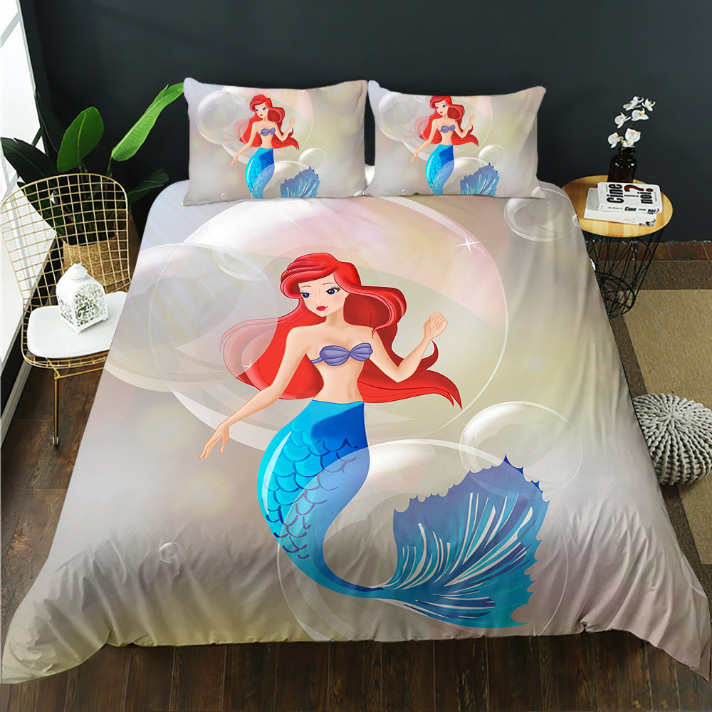 Mermaid-themed bedding set on a bed in a room with decor elements.